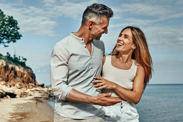 istock Attractive couple embracing on the beach on a sunny day. 1334547920