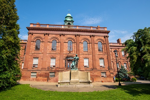 Albany, USA - August 8, 2021. Joseph Henry Memorial Building with Joseph Henry Statue in front, Albany, New York, USA