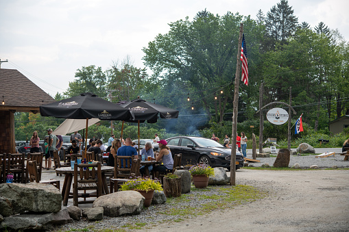 Schroon Lake, USA - August 7, 2021. People dining outdoor at Sticks & Stones restaurant in Schroon Lake in Upper New York, USA