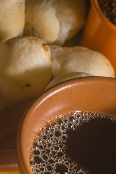 istock cheese buns with coffee on a yellow table and brown china, copy space 1334556479