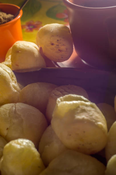 istock cheese buns with coffee on a yellow table and brown china, copy space 1334556559