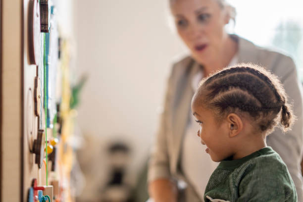 istock Young boy playing with a sensory board at speech therapy 1334556566