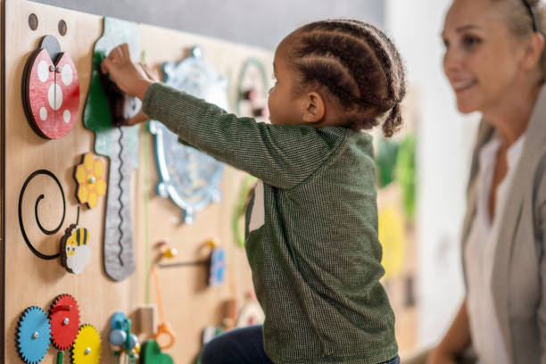 istock Preschool boy playing with a sensory board at speech therapy 1334556579