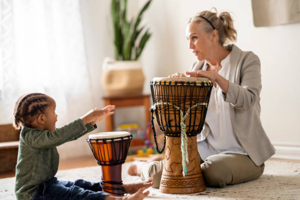 istock Occupational therapist using music during play therapy with a child 1334556589