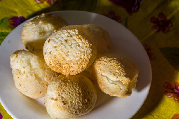 istock cheese buns with coffee on a yellow table and brown china, copy space 1334557499