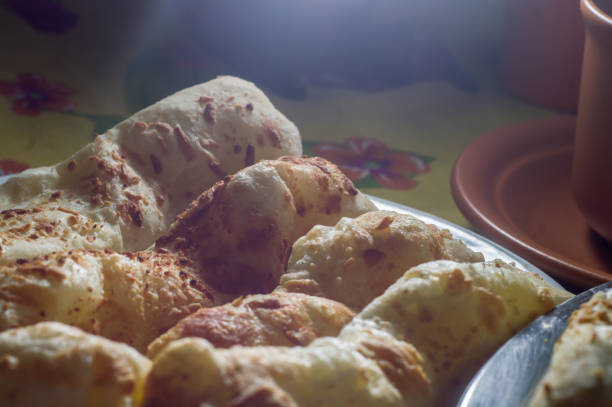 istock cheese buns with coffee on a yellow table and brown china, copy space 1334558539
