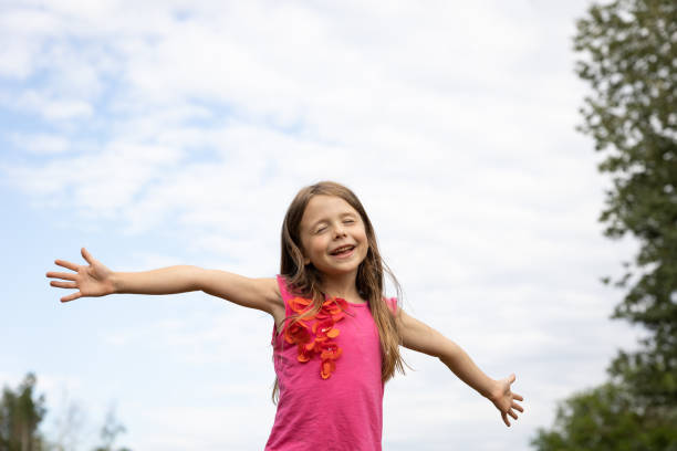 istock Young girl with arms outstretched 1334562695