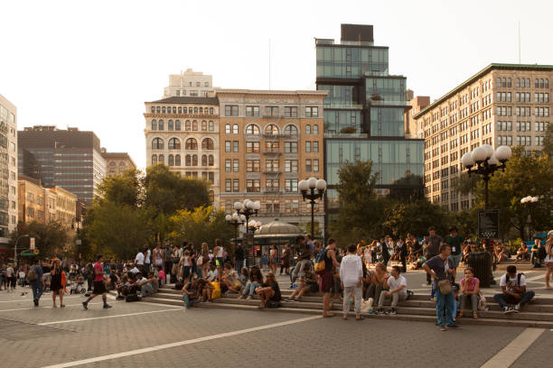 Union Square Park New York City, USA - August 20, 2016: Crowds hanging out by the steps at Union Square Park. union square new york city stock pictures, royalty-free photos & images