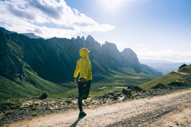 istock Woman ultramarathon runner stretching lges while running at mountain top 1334563728