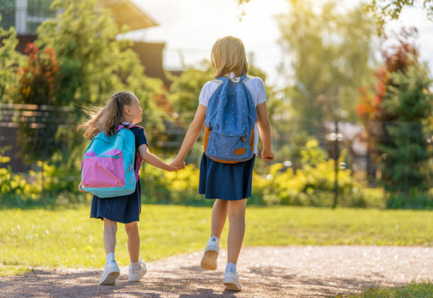 istock Girls with backpack are going to school 1334565446