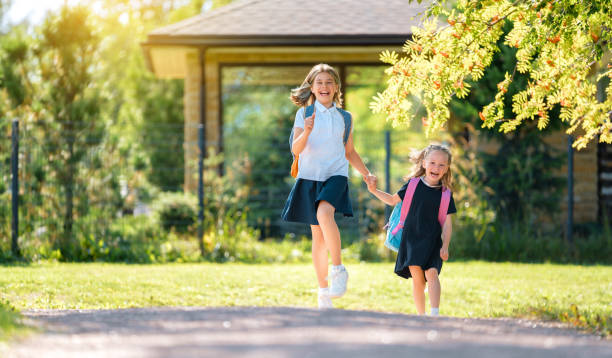 istock Girls with backpack are going to school 1334565457