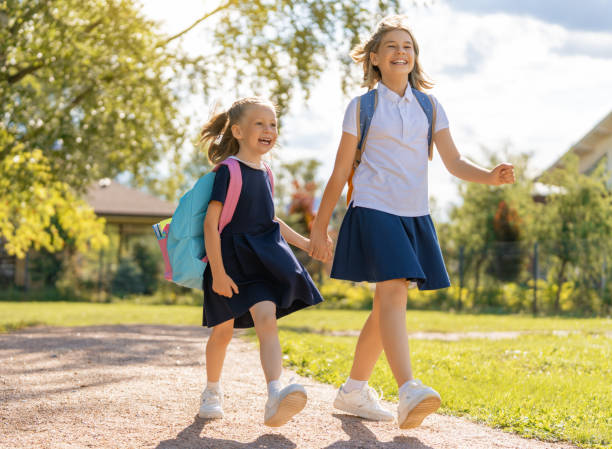 istock Girls with backpack are going to school 1334565459