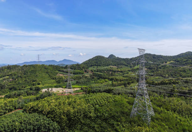 istock High voltage post, High voltage tower sky background on the mountain forest, Electricity poles and electric power transmission lines against countryside 1334565585