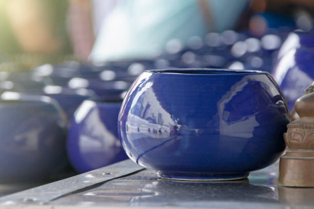Purple monk's alms bowl and coin to blessing stock photo
