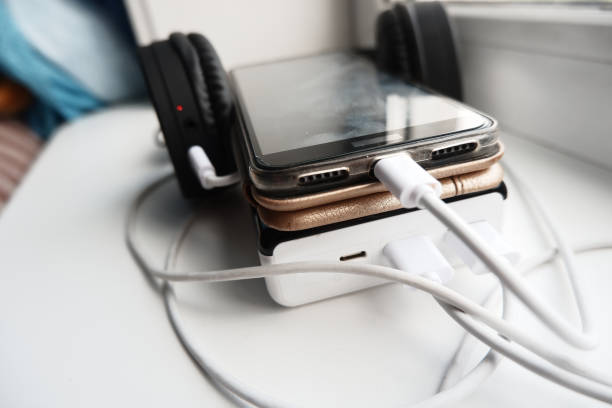 istock cell phone and bluetooth headphones are charged using powerbank 1334567062