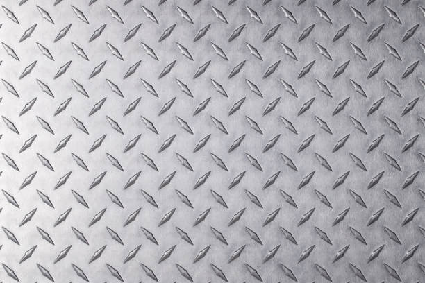 istock shiny sheet of iron, silver metal as a background. steel texture with diamond pattern. 1334567922