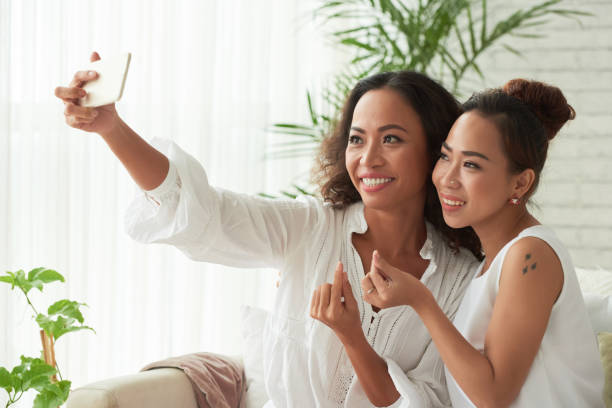 istock Pretty Women Doing Finger Hearts 1334571348