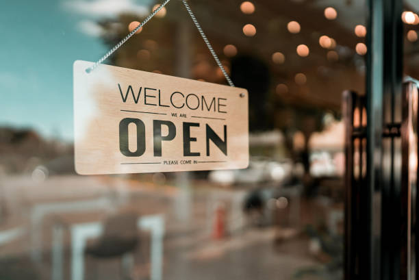 Open cafe or restaurant. Open sign board on glass door in modern cafe coffee shop stock photo