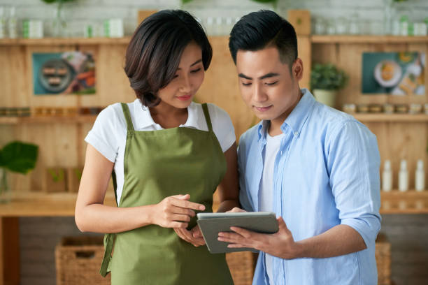 istock Business Couple Reading List on Tablet 1334574793