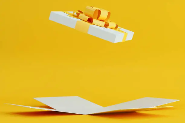 Open Gift Box With Yellow Ribbon On Yellow Background With Shadow