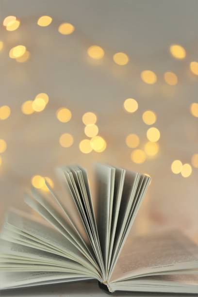 istock Reading books. Book pages close-up on shining bokeh background 1334580119