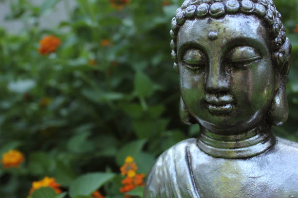 istock Buddha Statue in Garden with green background 1334581754