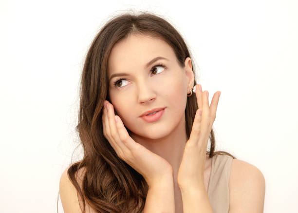 istock young woman  applying a face cream 1334581833