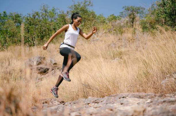 istock African american woman athlete runner exercise training and jumping  outdoors in beautiful mountain nature landscape. Active health and motivation lifestyle and Adventure Concept. Fitness and workout on outdoors. 1334584482
