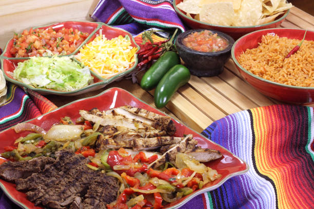 istock Beef and Chicken Fajita Dinner With Rice and Tortillas in Rustic Setting 1334585712