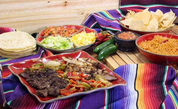 istock Beef and Chicken Fajita Dinner With Rice and Tortillas in Rustic Setting 1334585719