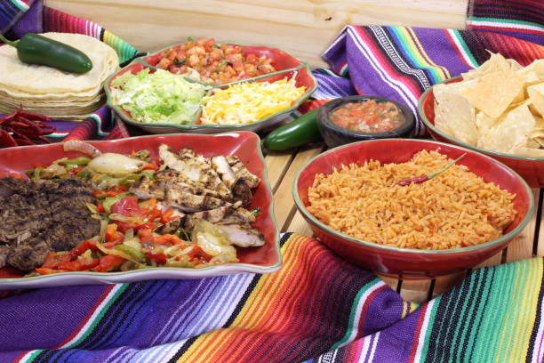 istock Beef and Chicken Fajita Dinner With Rice and Tortillas in Rustic Setting 1334585728