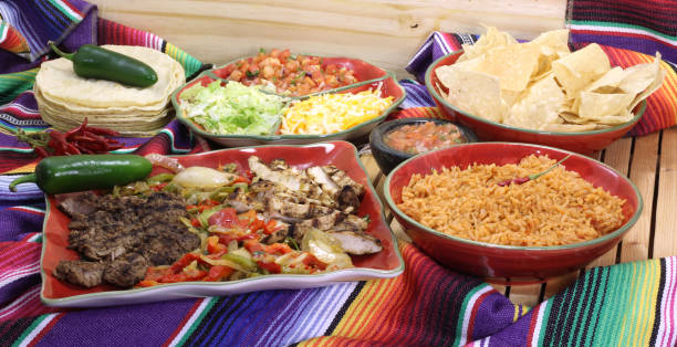 istock Beef and Chicken Fajita Dinner With Rice and Tortillas in Rustic Setting 1334585748