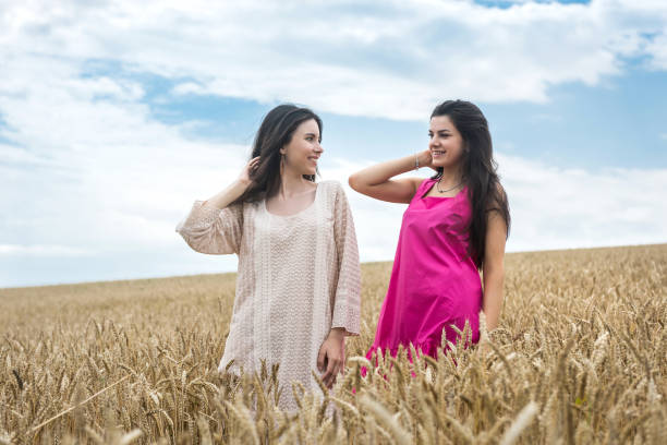 istock two pretty sister enjoy freedom in wheat field 1334586873