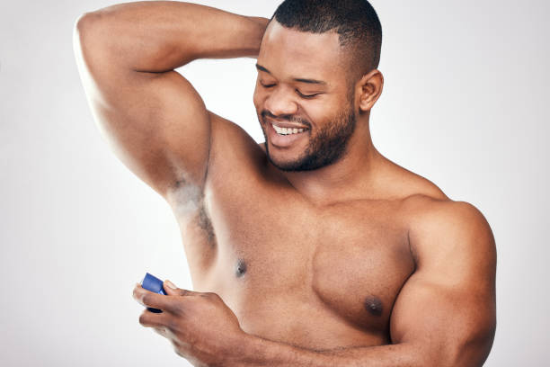 istock Studio shot of a handsome young man spraying deodorant on his armpit against a white background 1334588066