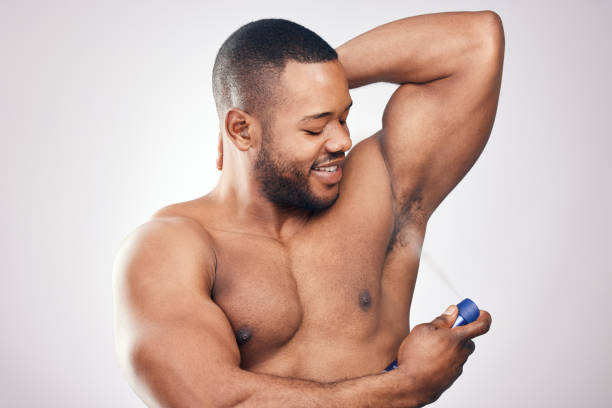 istock Studio shot of a handsome young man spraying deodorant on his armpit against a white background 1334588070