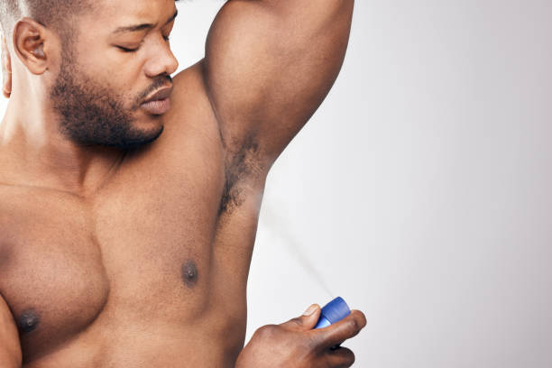 istock Studio shot of a handsome young man spraying deodorant on his armpit against a white background 1334588072