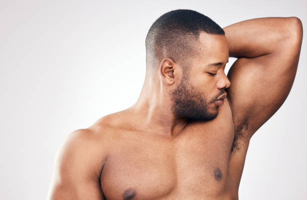 istock Studio shot of a handsome young man smelling his armpit against a white background 1334588074