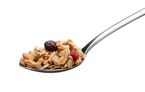 spoonful of granola spoonful of granola isolated on white background granola photos stock pictures, royalty-free photos & images