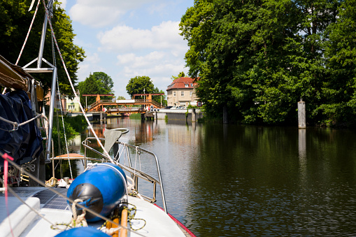 Sailboat waiting in front of canal lock, travel by sailboat in Germany, summer vacations