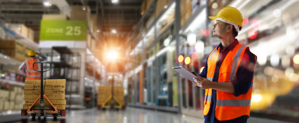 Manager warehouse. Worker checking and loading products and tracking delivery with a tablet on global network. Import export.  Smart logistics and transportation concept.