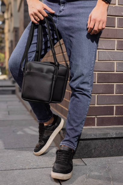istock Unrecognizable man holding two messenger bags 1334598060