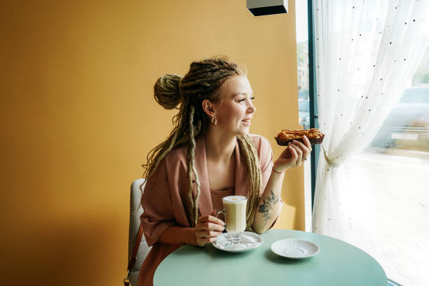 istock Caucasian woman with dreadlocks sitting in cafe. 1334599531