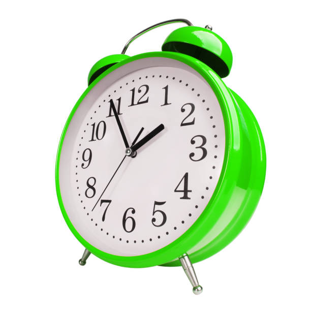 istock Big green alarm clock on white background 1334602199