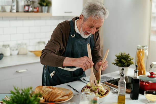 istock Happy smiling man cooking delicious food. 1334602679