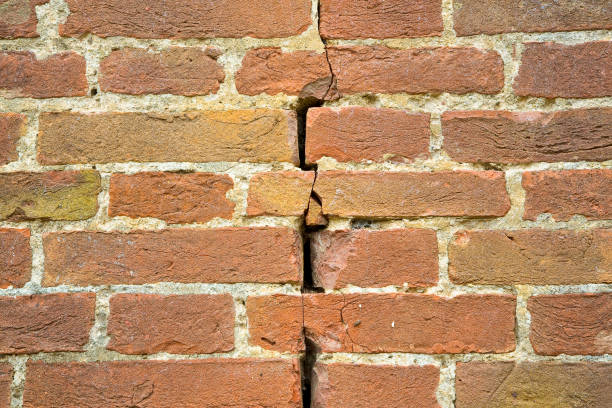 istock Deep crack in a old damaged brick wall cause due to subsidence of foundations structural failures 1334602750
