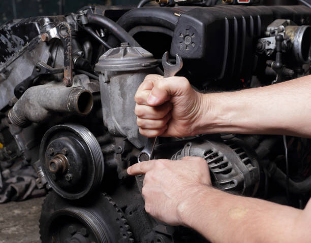 istock Car service - Engine repair mechanic hands with wrench generator  nut 1334603280