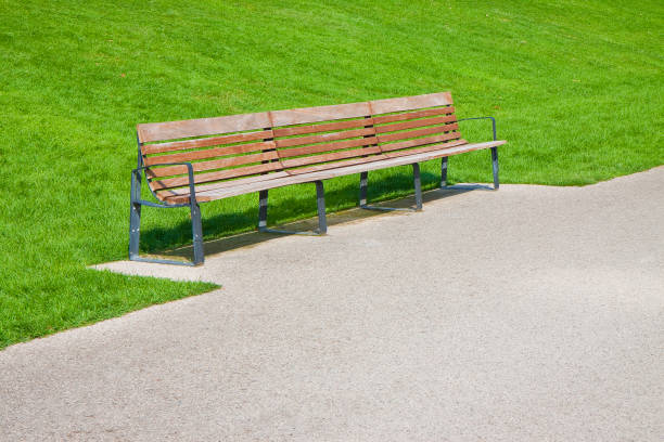 istock Wooden bench in a italian public park - image with copy space 1334607197