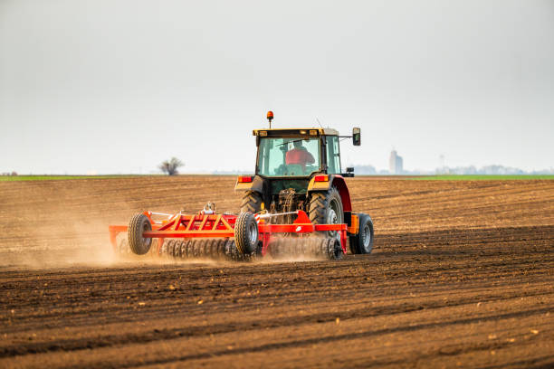 istock Farmer in tractor preparing land with seedbed cultivator 1334607311