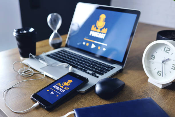 istock Podcast concept on laptop and smartphone screen over wooden table 1334608618