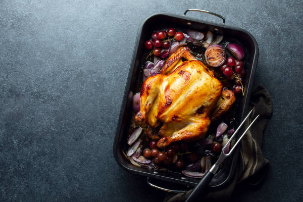 istock Fried chicken or turkey in a dark baking tray, top-down view 1334609891